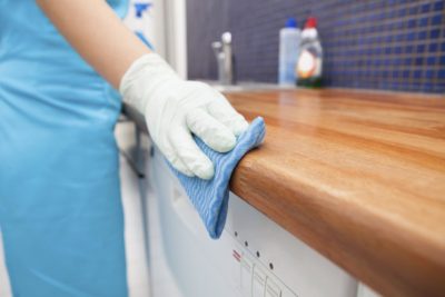 Cleaner polishing a kitchen counter in a Colorado home.